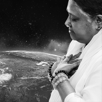 Amma with hands on heart near globe