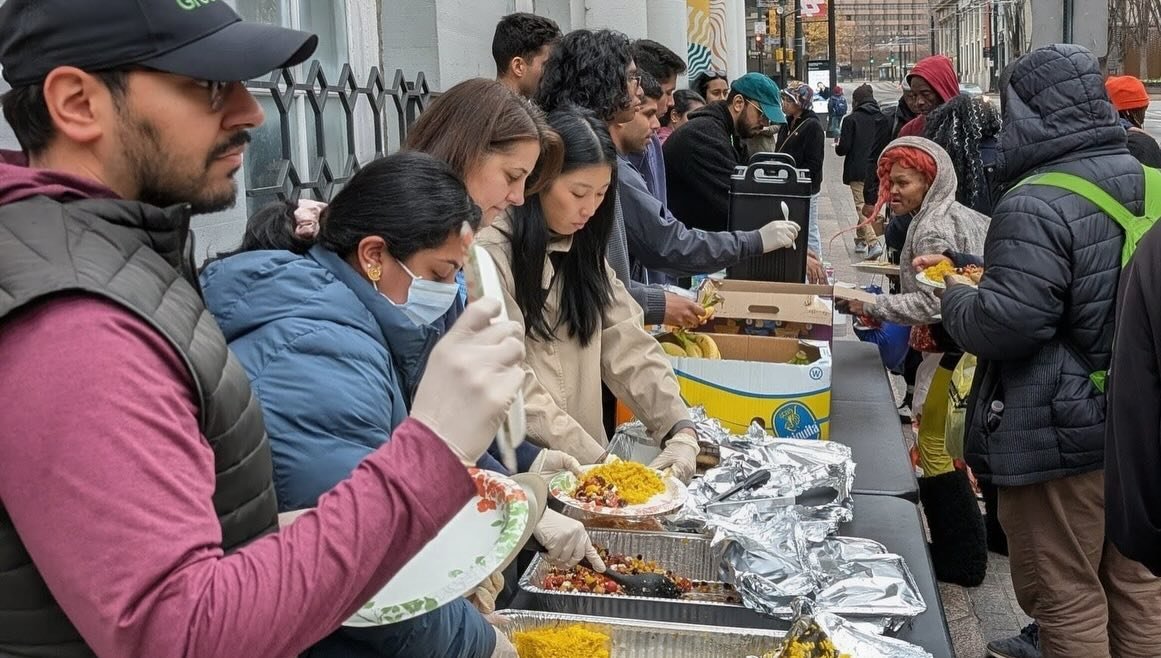 Mother's Kitchen volunteers serving a meal