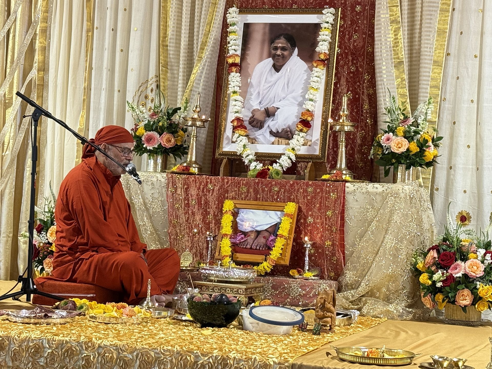 Swami leading a program before the altar at MA Center LA