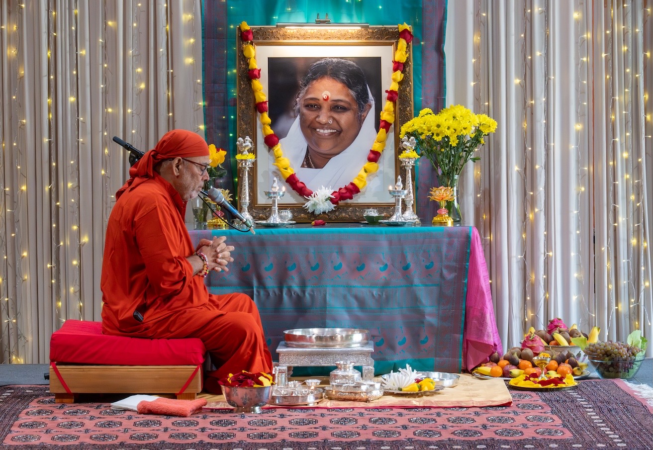 Devotional offering before Amma's portrait