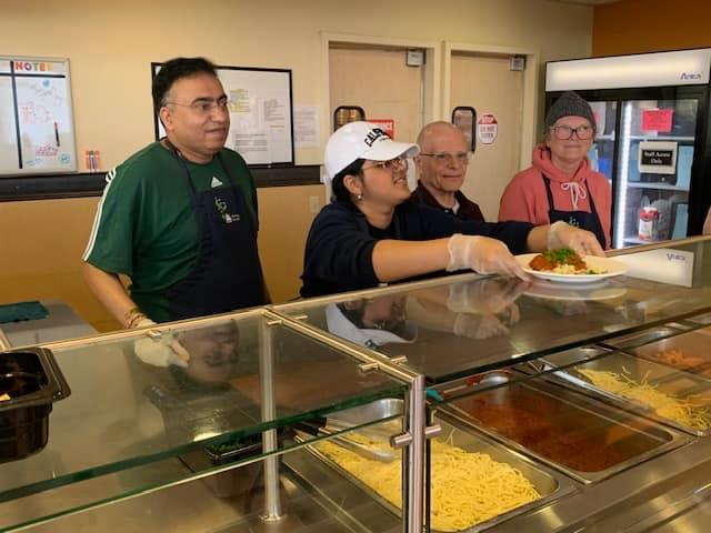 Mother's Kitchen volunteers serving a meal