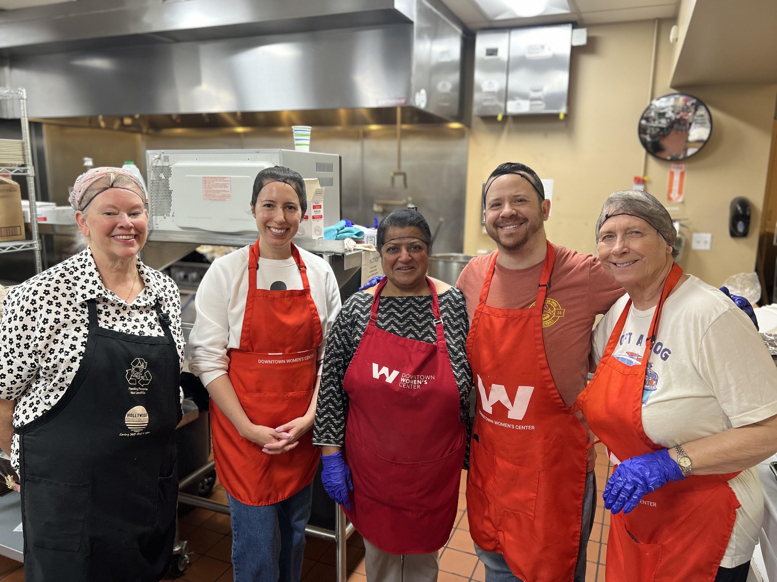 Mother's Kitchen volunteers in aprons in the Downtown Women's Center kitchen