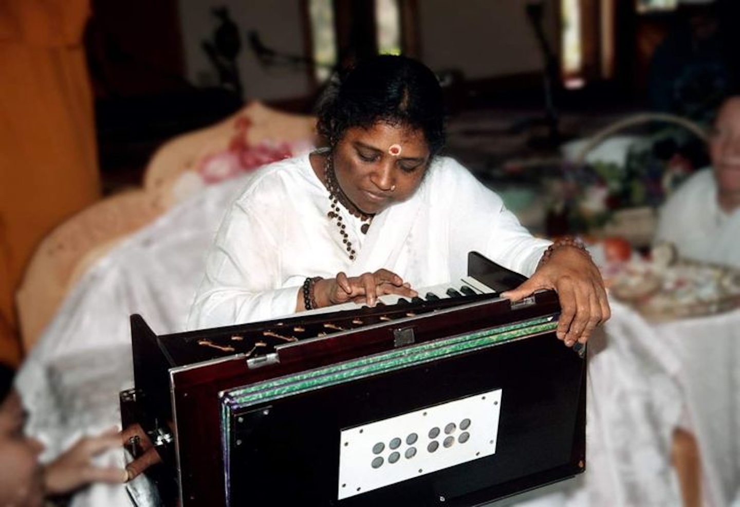 Amma playing harmonium