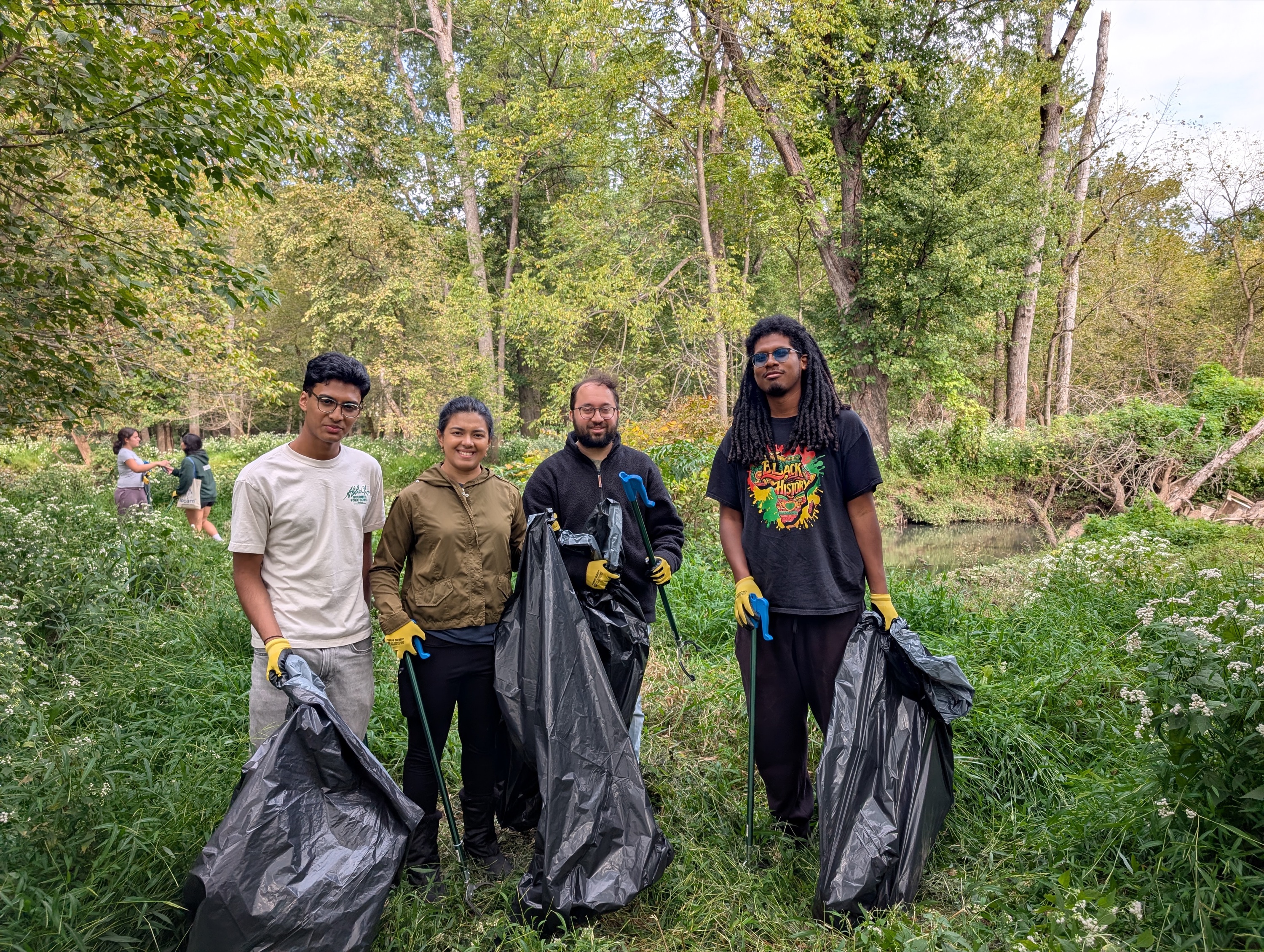AYUDH New Jersey volunteers and Bridgewater satsang members with trash bags during a watershed cleanup