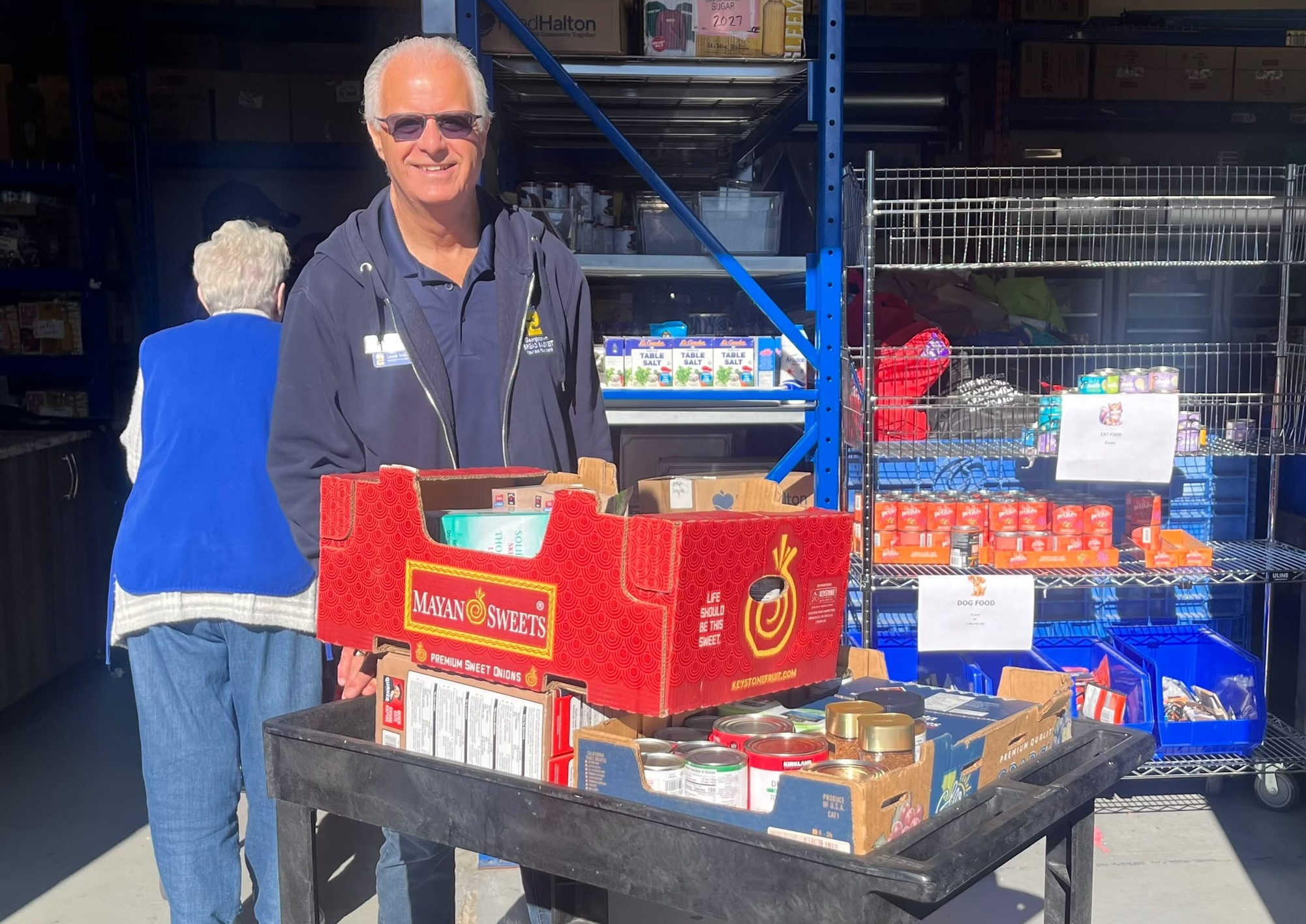 Georgetown Bread Basket volunteer with food drive donations
