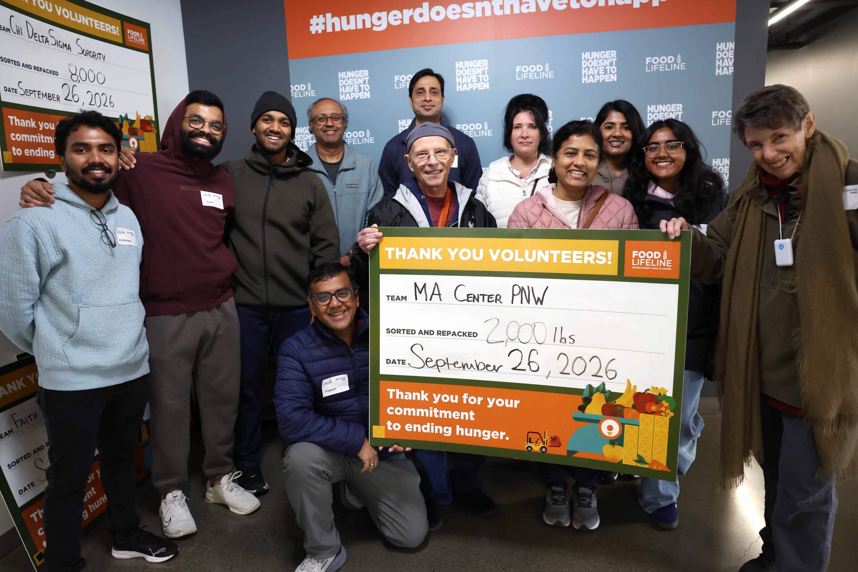 MA Center PNW volunteers at Food Lifeline in Seattle holding a thank-you sign for repacking 2,000 pounds of rice