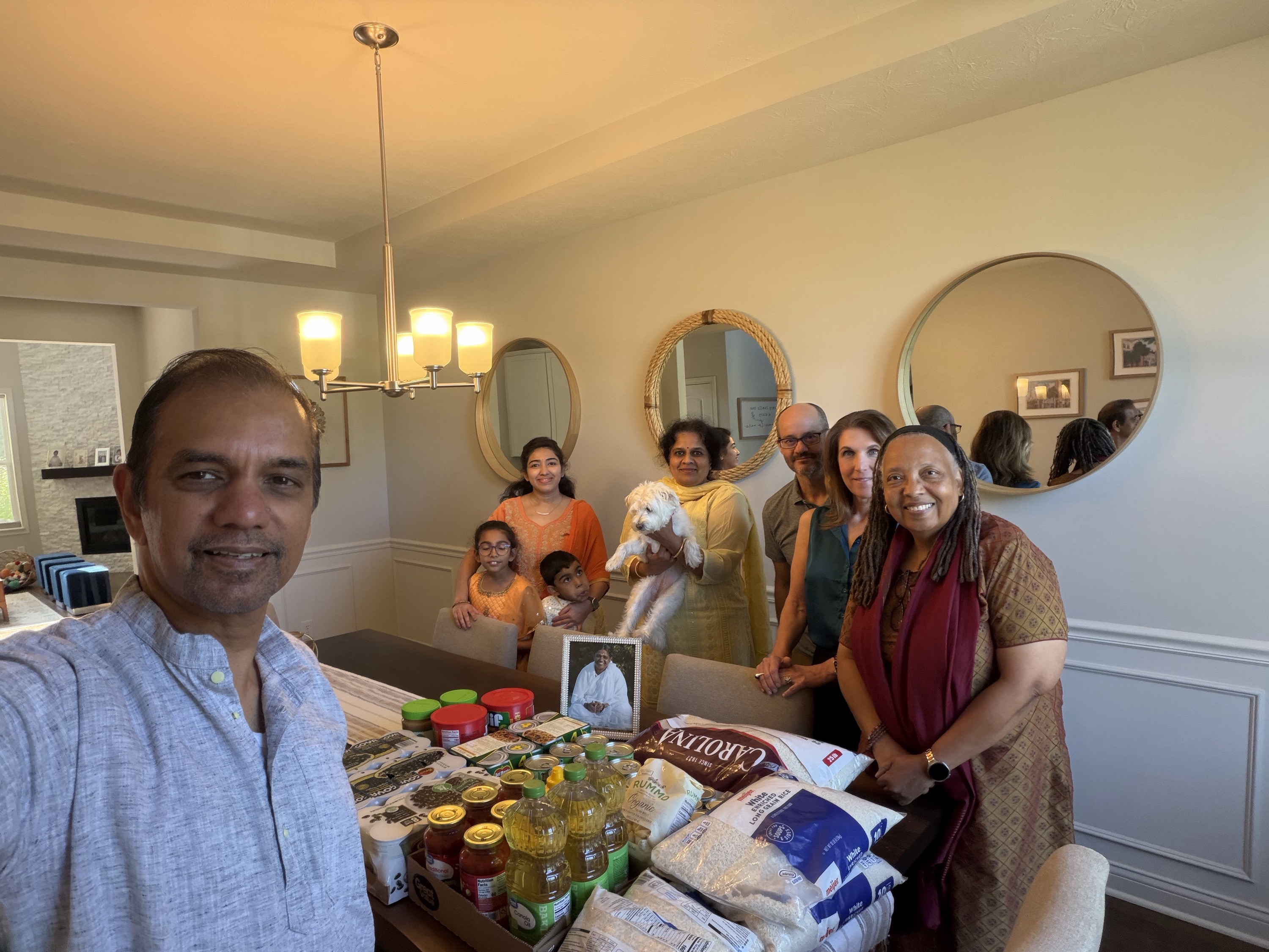 Indianapolis Satsang members gathered around a table of donated food for Second Helpings