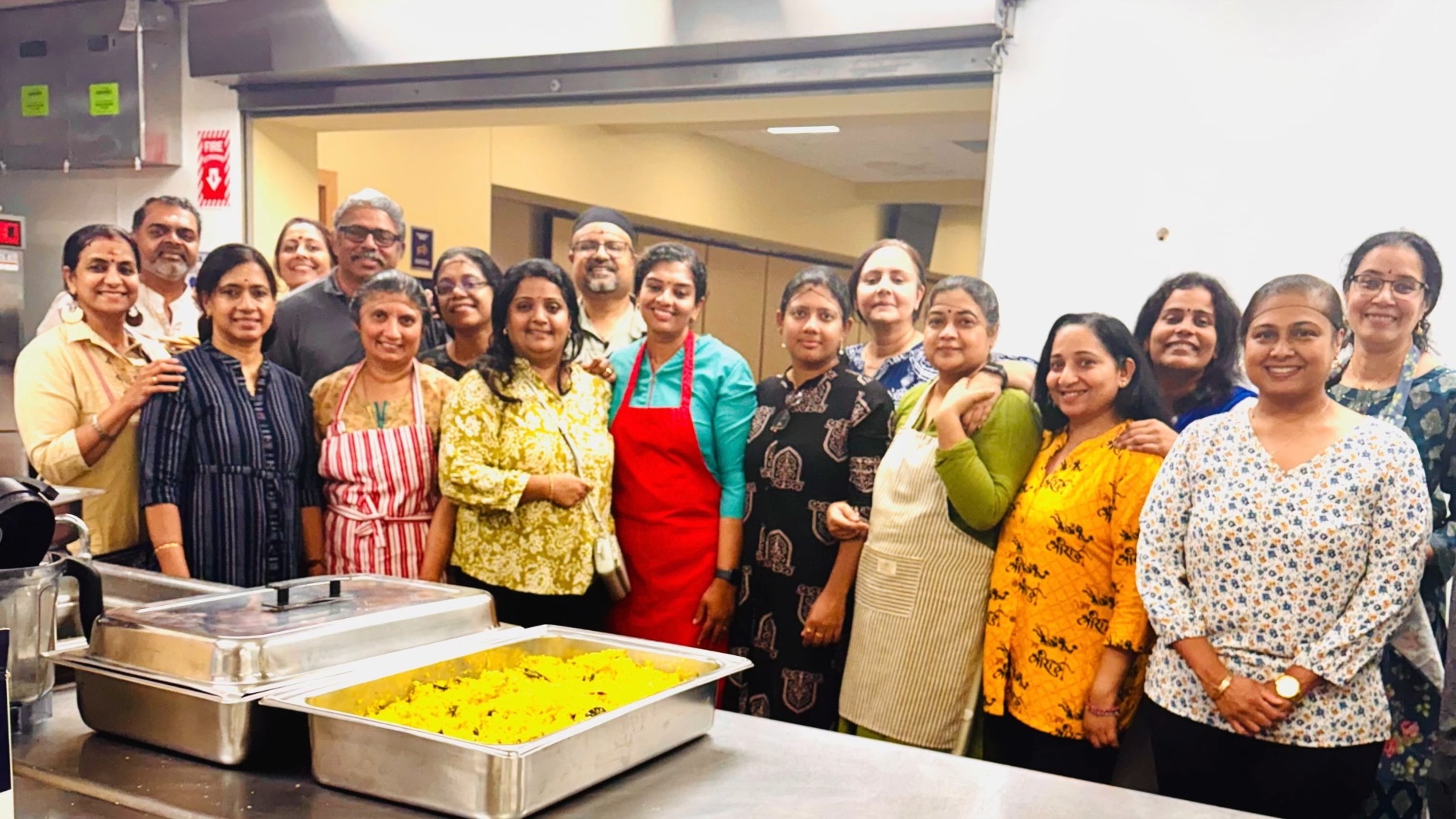 Minnesota Amma Satsang volunteers gathered in the Hindu Mandir kitchen with trays of food for the Kerala Sadya