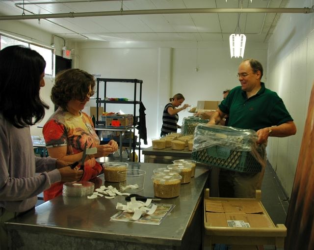 Volunteers repackaging rice at the Quest food bank