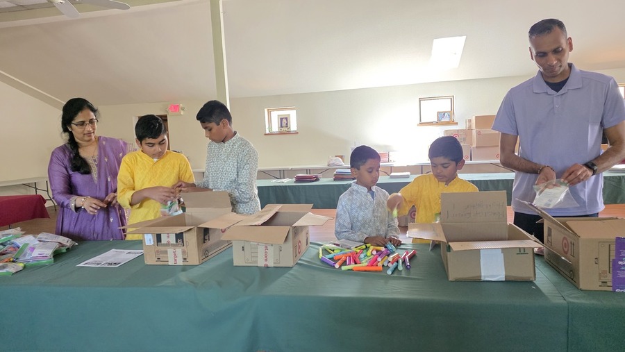 Volunteers with backpacks prepared for students