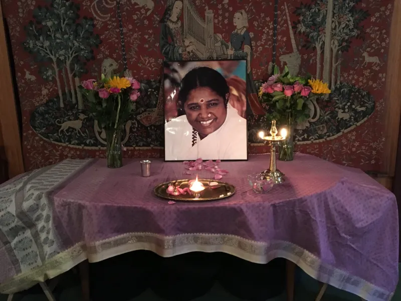A home satsang altar with Amma's photo