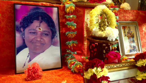 Altar with Amma's picture, garland and flowers