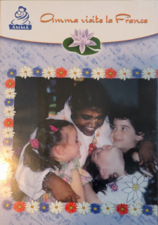 Amma with three children on Her lap and one standing beside Her.