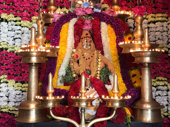 Lord Ayyappa with lamps and flower garlands