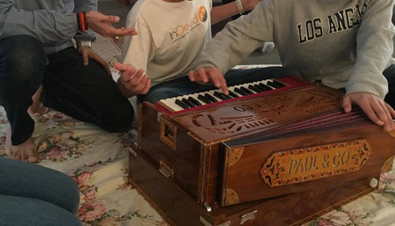 In-Person Bhajan Practice - Saturdays, 3:00 PM Hands playing harmonium