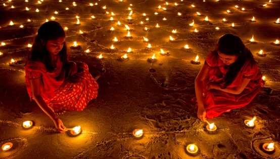 Girls lighting clay lamps
