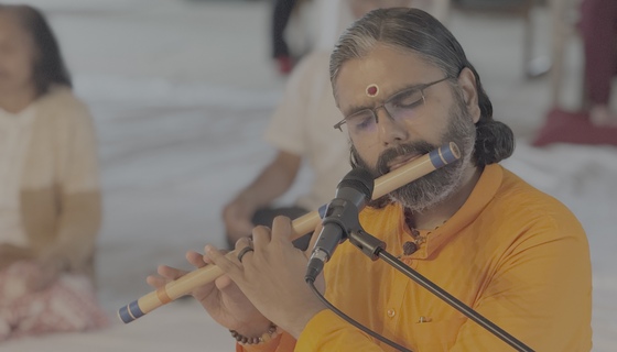 Ramanandamrita Swamiji playing bansuri flute