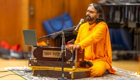 Ramanandamrita Swamiji singing and playing harmonium