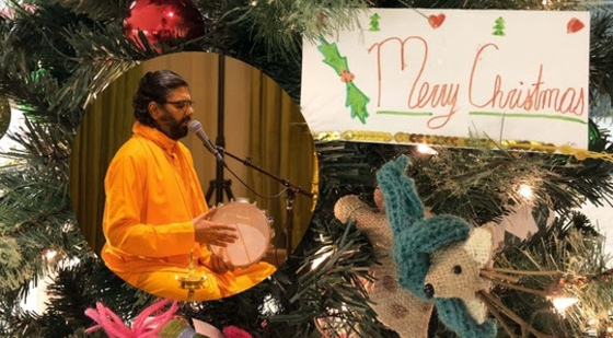 Ramanandamrita Swamiji singing over Christmas tree