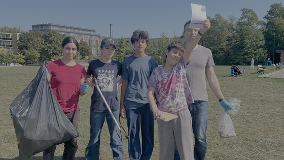 Volunteers holding bags of collected trash