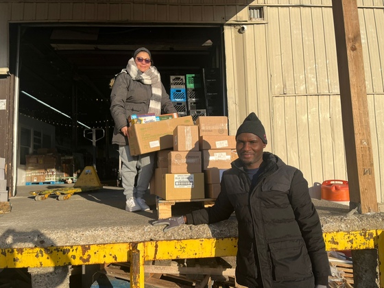 Volunteers at Feed Scarborough unloading food donations 'rescued' by Amma Canada volunteers