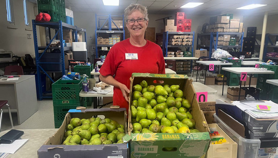 Staff at Bluffs Food Bank with donation of Amma Canada pears