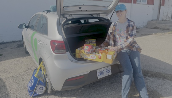 Volunteer with food in trunk