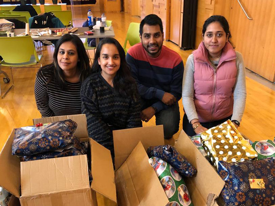 AYUDH members and mentor with wrapped gifts