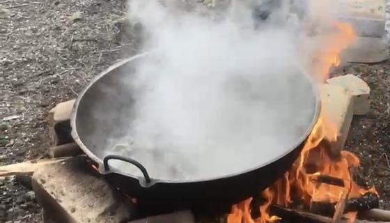 Sap boiling in pot over fire