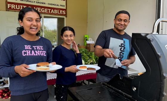 Father and daughters eating veggie burgers