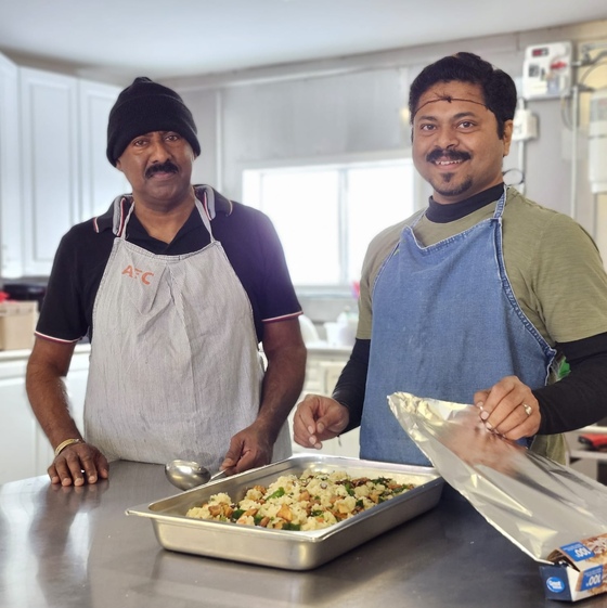 Kumar Uncle & Gautam serving food