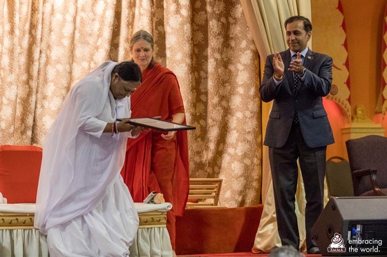 Amma accepting the congressional commendation from Congressman Krishnamoorthi Amma accepting the congressional commendation from Congressman Krishnamoorthi
