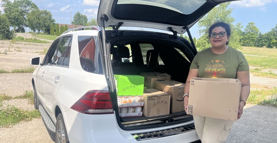 Amma Canada volunteer with rescued non-perishable food in her car
