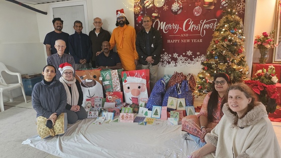 Ramanandamrita Chaitanya with Amma Canada volunteers and holidays gifts and cards