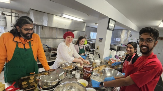 Volunteers making chocolate chip cookies