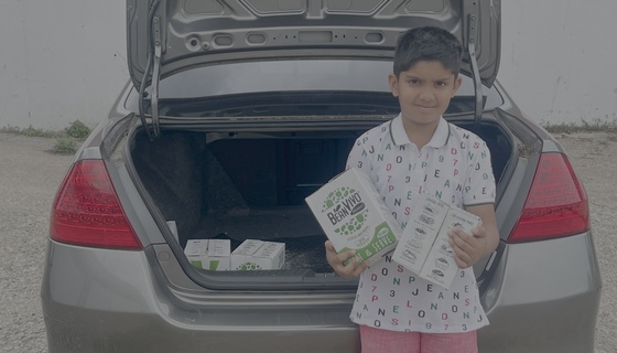 Boy with donated chilli packets