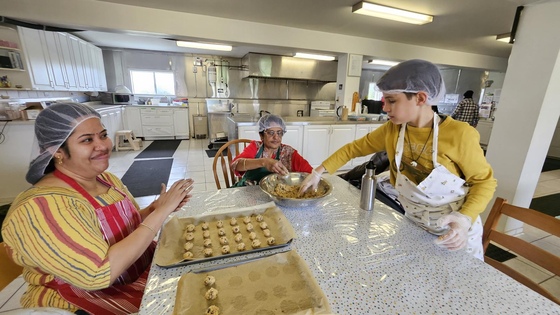 Amma Canada volunteers shaping cookies to bake