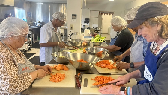 Volunteers chopping veggies for chilli