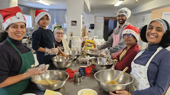 Volunteers baking cookies in Amma Canada kitchen