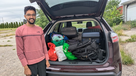 AYUDH TO volunteer with car trunk full of donated items