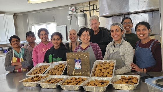Group of bakers with cookies in Amma Canada kitchen