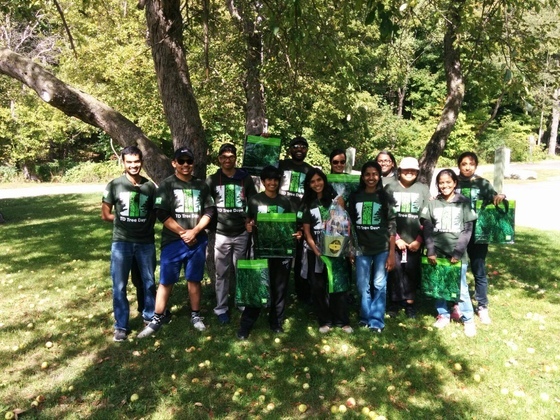 Group of youths in AYUDH green t-shirts in front of a big tree