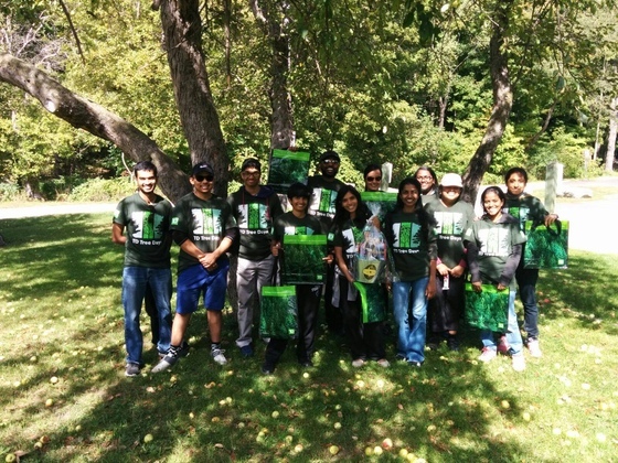 Tree planting on TD tree day Group of youths in AYUDH green t-shirts in front of a big tree