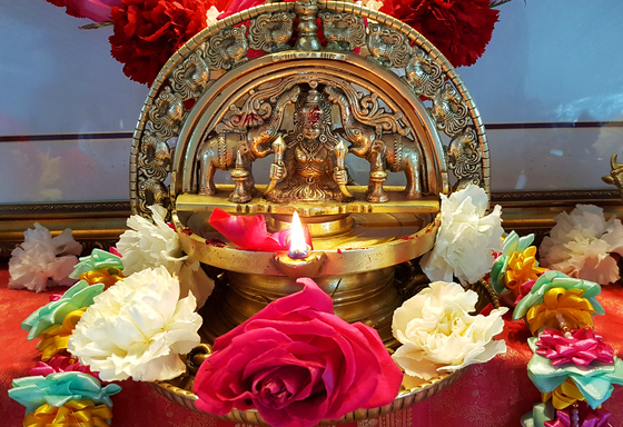 Brass lamp surrounded with fresh flowers