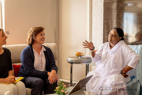 Dorothy Bush Koch and Patricia Reilly Koch had a meeting with Amma.