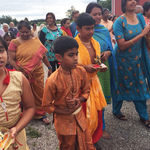 Two boys in procession with Krishna murtis