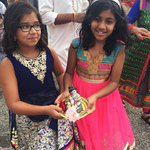 Two girls in procession with Krishna murtis