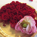 Rose and a lotus blossoms on a brass plate