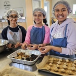 Three young volunteers handling cookies