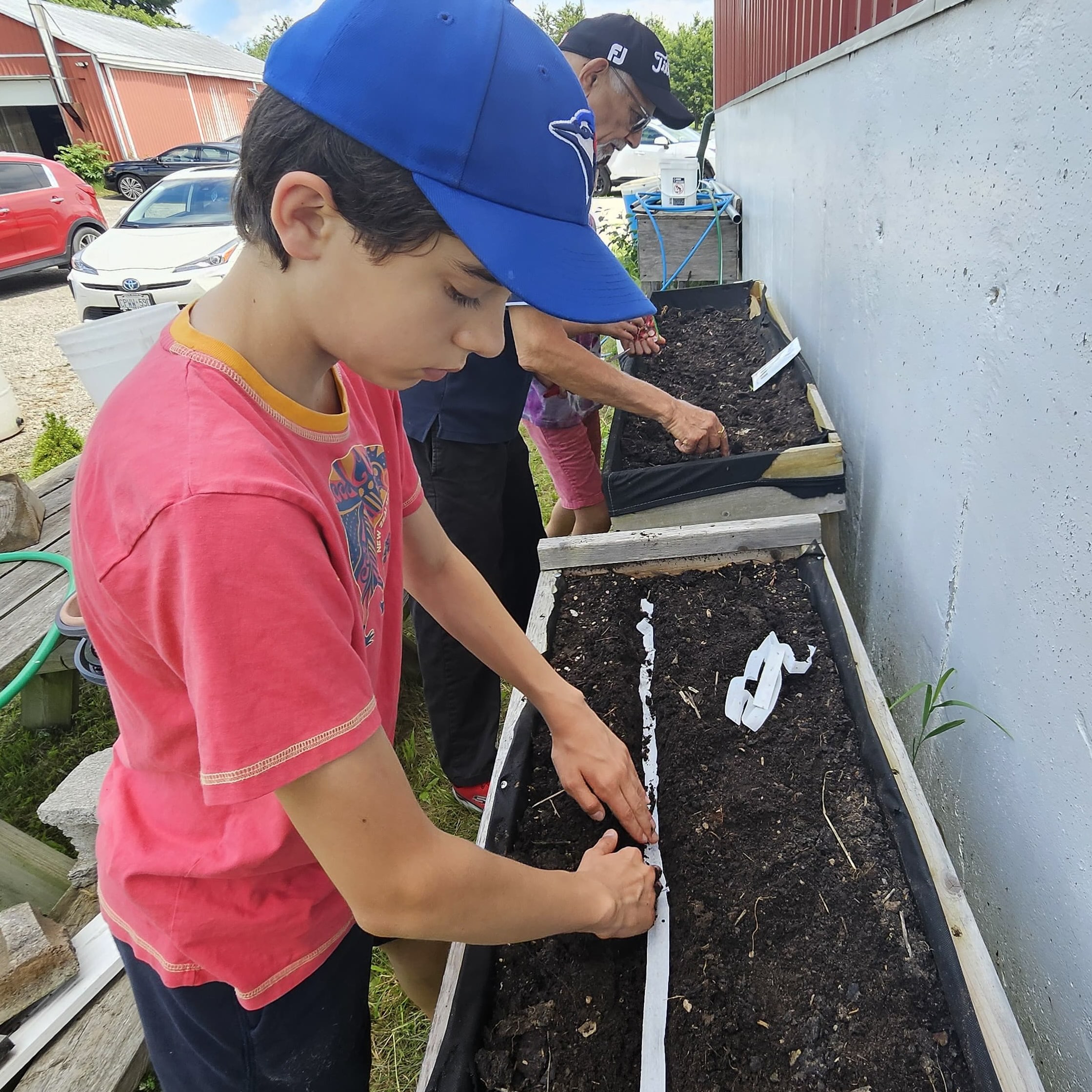 Boy planting seeds in planter